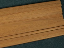 A custom plastic extrusion with a wood grain profile